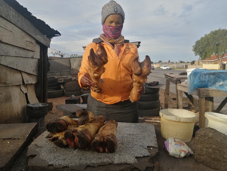 Photo of woman holding cow feet
