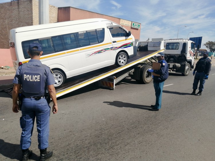 Photo of a taxi being loaded  on to a flatbed truck