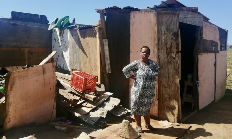 Photo of a woman and a shack