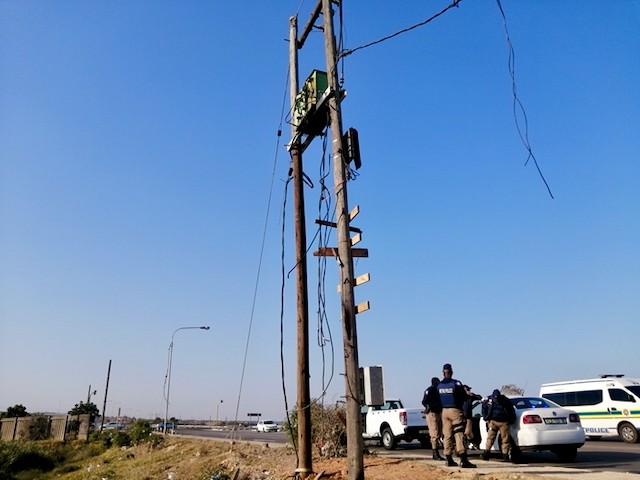 Photo of police and an electricity pole