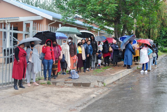 People wait in the rain for hours outside Stanford Terrace clinic
