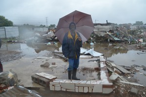 Photo of man in ruins of shack