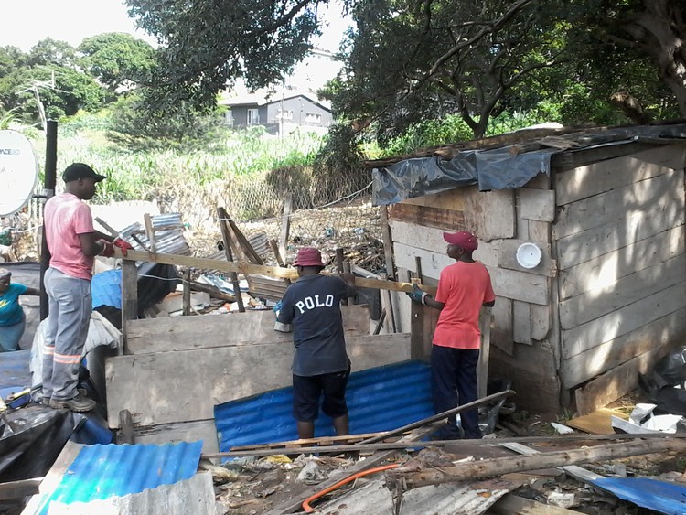 Photo of shack being rebuilt