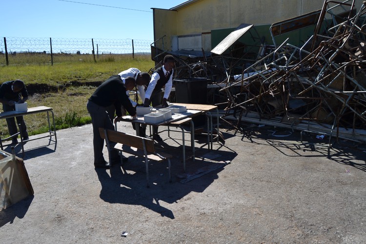 Photo of students in destroyed classroom