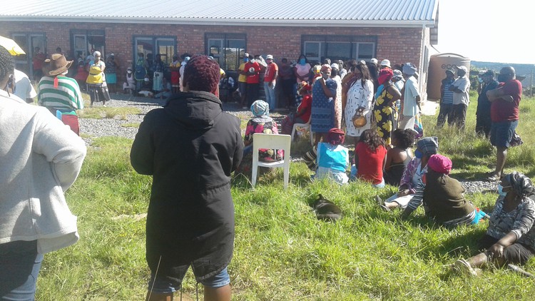 Photo of community member standing around during a meeting