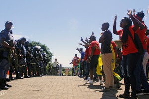 Photo of protesters facing police