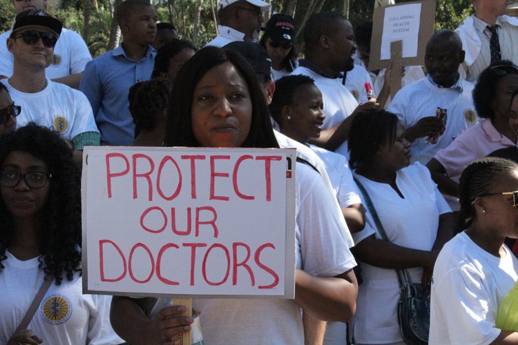 Photo of health worker with sign