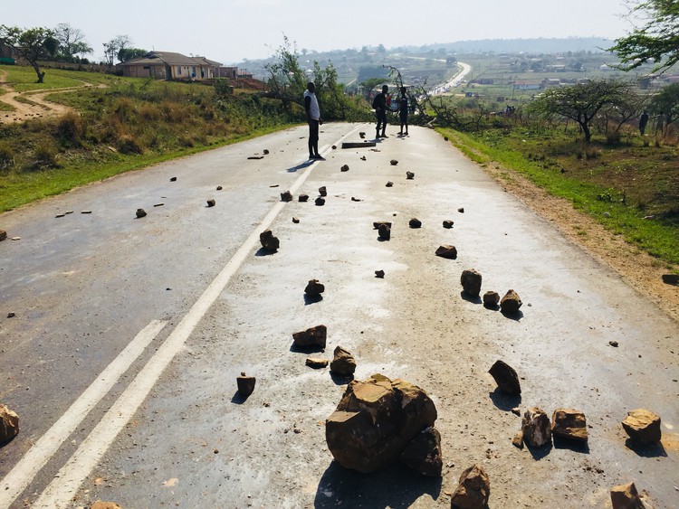Photo of road with rocks on it