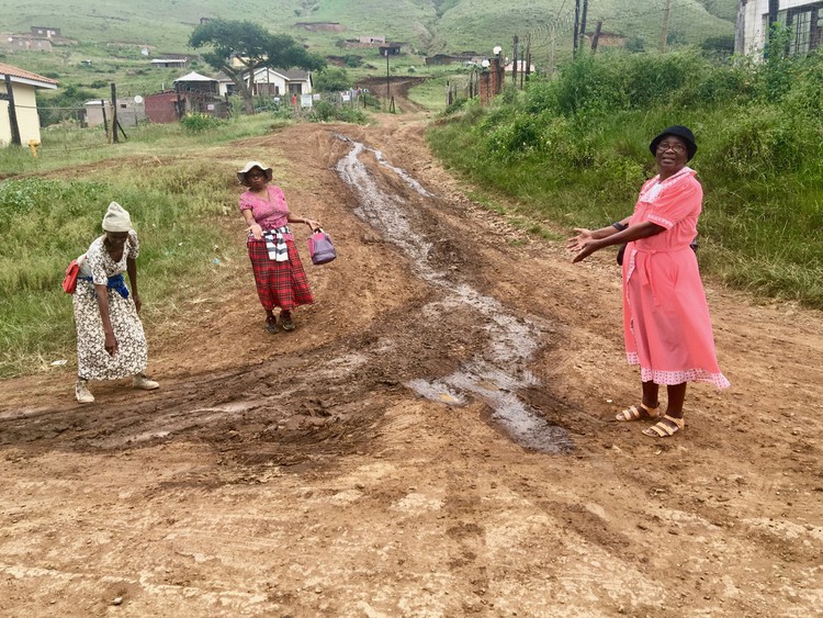 Photo of three women on a dirt road