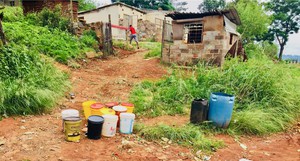 Photo of empty water containers outside a house