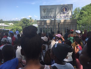 Photo of students outside the college's gates