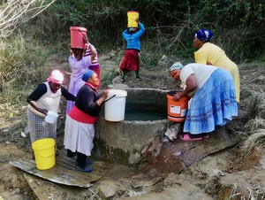 Photo of women fetching water with buckets