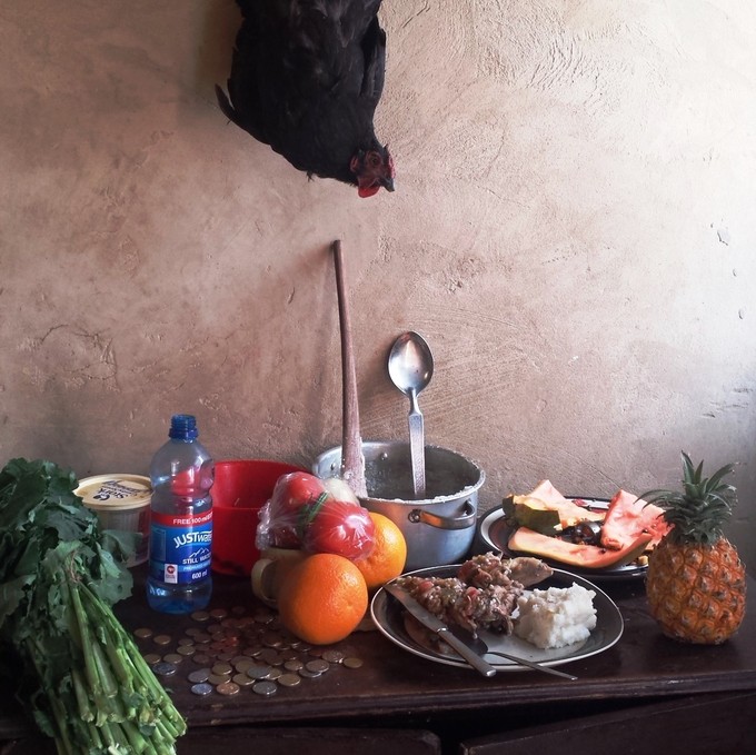 Photo of a table with food and a chicken
