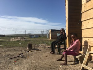 Photo of two children outside shack