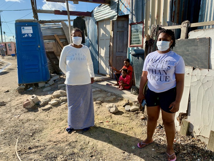 Photo of two women in an informal settlement