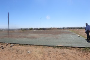 Photo of man and derelict netball field