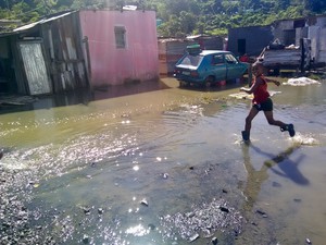 Photo of flooded are and a child running