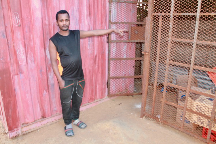 Photo of a man at his shop door