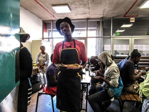 Photo of a young man working in a soup kitchen