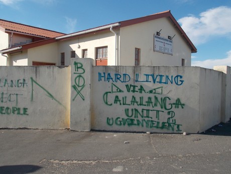 Photo of church with gang graffiti on it.