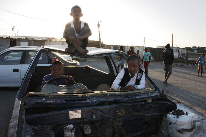Photo of children on a stripped down car