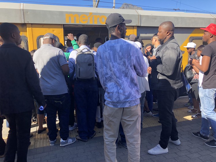 Photo of commuters boarding a train