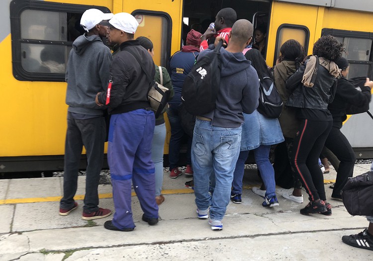 Photo of people boarding a train