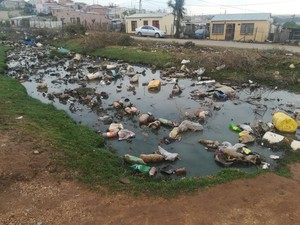 Photo of sewage flowing past houses