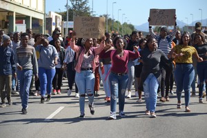 Photo of students marching to the campus head office