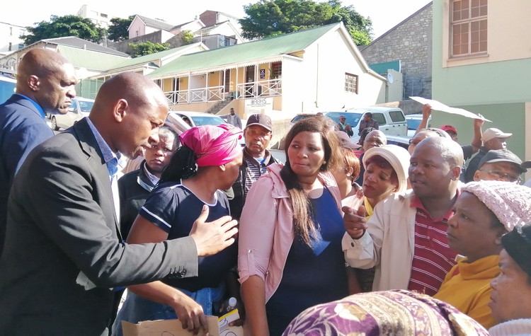 Photo of politician talking to protesters