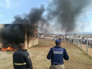 Photo of tyres burning outside an office building