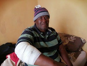 Photo of man with bandage on arm