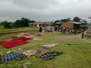 Photo of a building and blankets drying outside