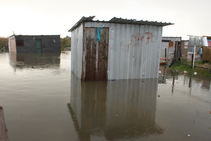 Partially submerged shacks in Qandu-qandu.