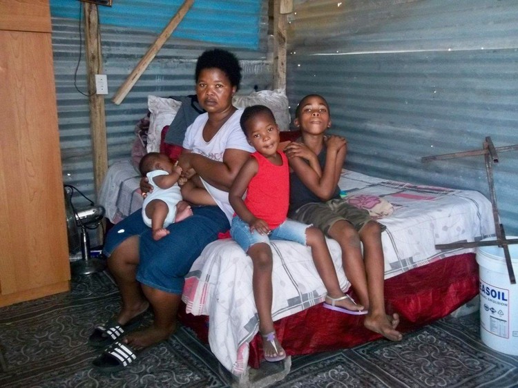 Photo of a family in a shack