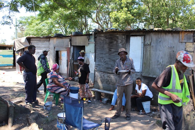 Photo of shacks and people