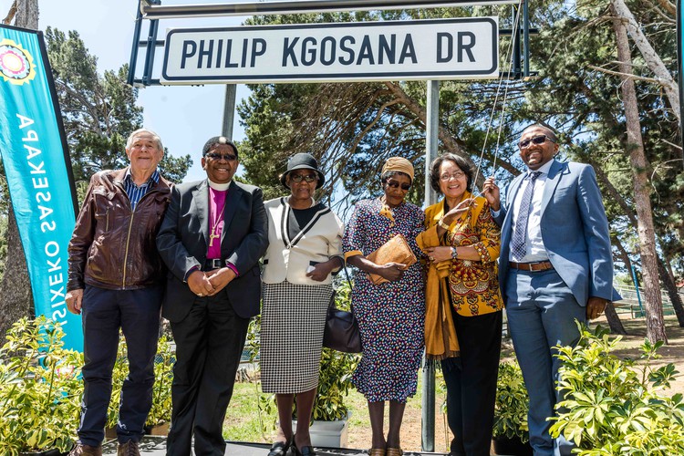 Photo of a group of people under a road name sign