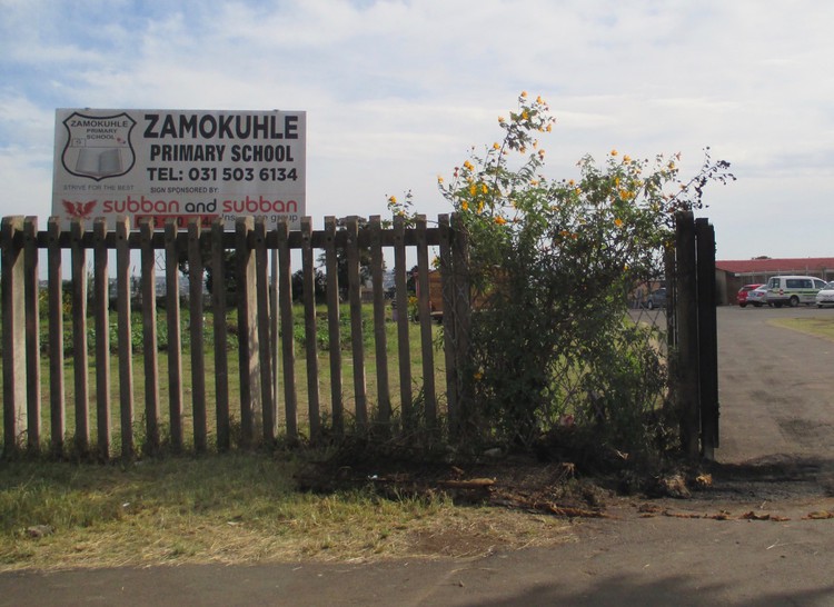Photo of a school gate and sign