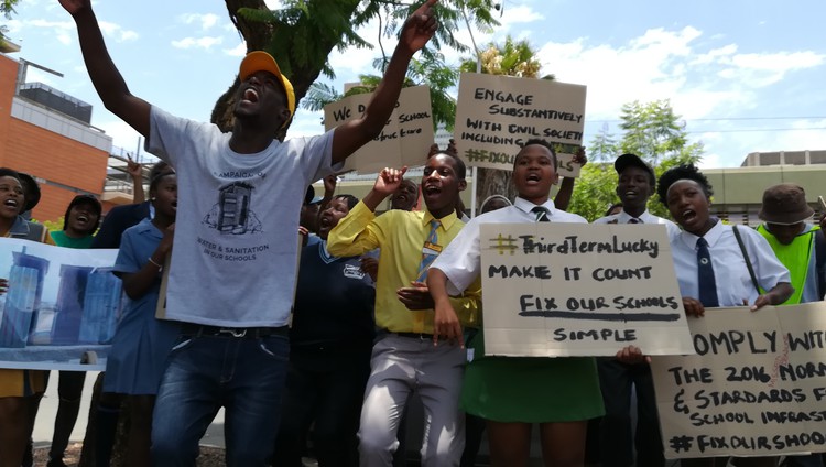 Photo of people holding placards