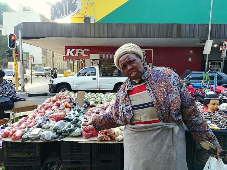 Photo of woman at vegetable stall
