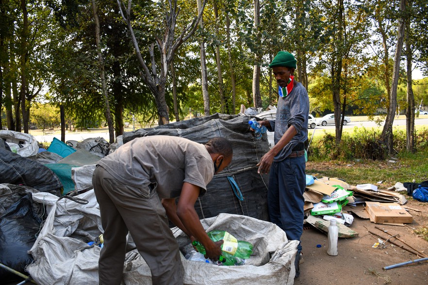 Refuoe Mokuoane and colleague Douglas Mali sort through all the recyclables into paper, plastic, cardboard and aluminium to take to the scrapyard. Photo: Julia Evans