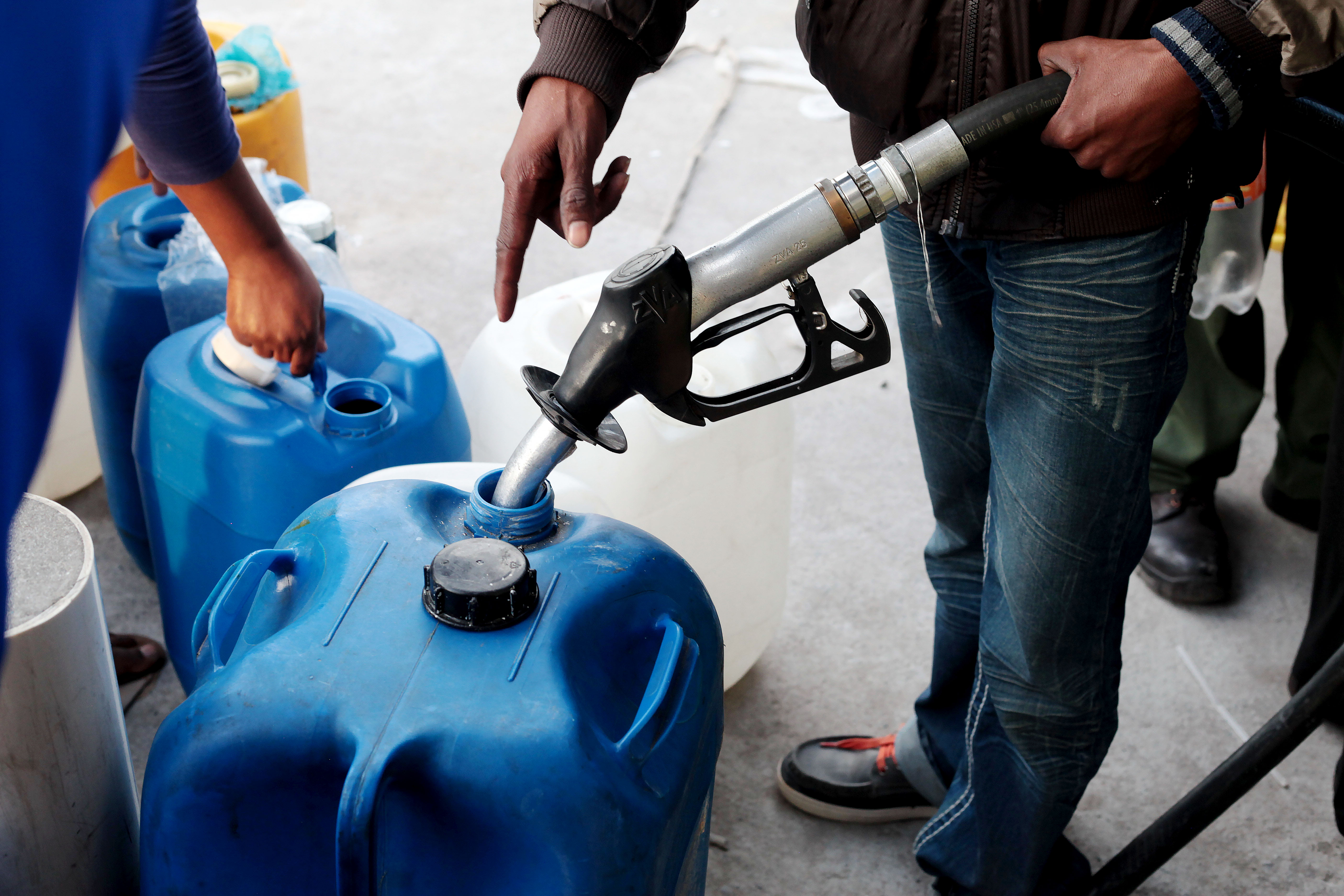 Photo of a petrol pump filling a drum