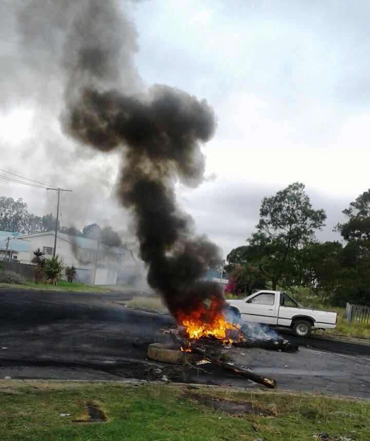 Photo of burning tyres and a pickup truck