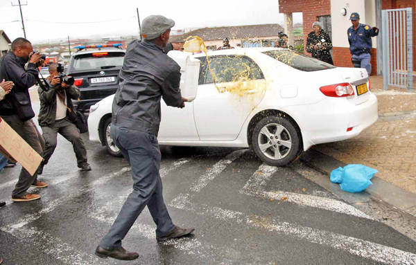 Protesters throw faeces on a government Premier Zille's convoy in Harare Khayelitsha in June 2013. 